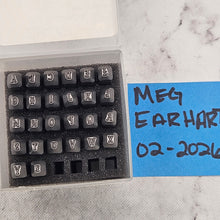 Set of letter tiles with a clear plastic holder on a marble surface
