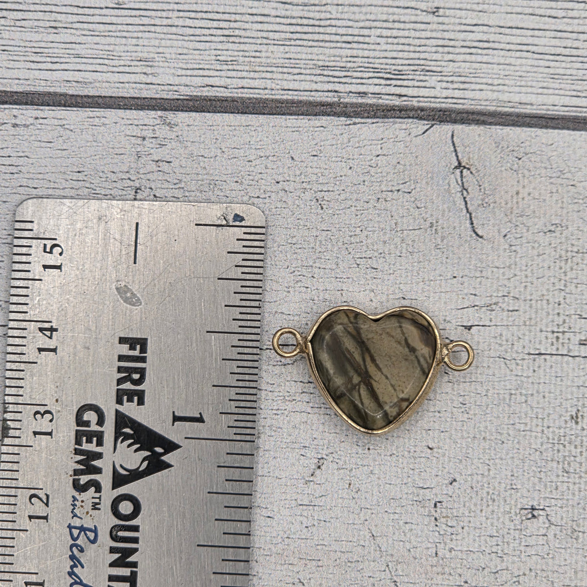 Stone bracelet piece with gold toned frame